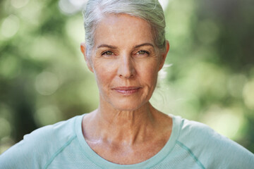 Portrait, exercise and senior woman with confidence, outdoor and training for wellness, healthy lifestyle and balance. Face, mature female and lady with serious workout, and retirement in a park