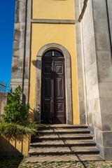 Old wooden door with a stone staircase on the side of a church