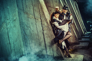 Portrait of a young beautiful couple in steampunk style. Victorian woman and man in alternative history.