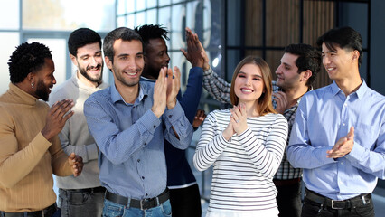 Business team of overjoyed professionals cheering, celebrating good sales result, financial goal...
