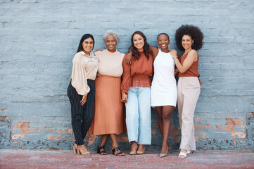 Portrait, group and business women smile standing on brick wall with mockup outdoors in city....