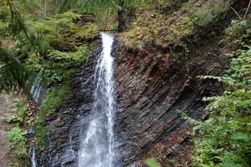 Fototapeta na wymiar Zhenetskyi Huk waterfall in Carpathians, Gorgany mountains, western Ukraine