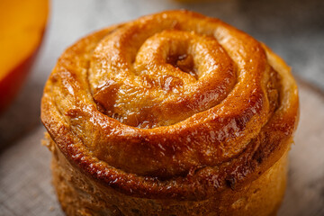 Portion of fresh baked sweet swirl bun roll on serving board