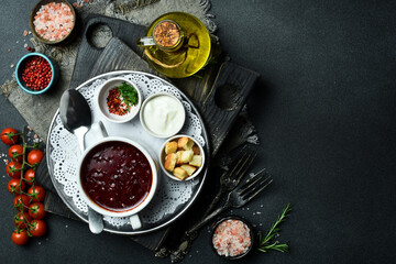 Beet soup. Borscht with veal. Close-up, dark background.