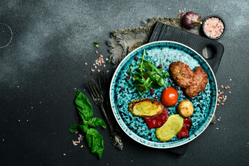 Meat cutlet with grilled vegetables on a plate. Close up. On a dark background.