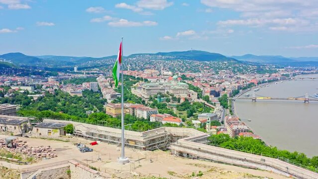 The aerial view of Budapest's city center showcases the iconic Danube river flowing through the heart of the city, with stunning view of Liberty bridge and Liberty statue 