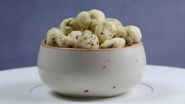 Rotating shot of Prickly Water Lily. Dried makhana also known as water lily. Fox nut. Makhanas. Lotus seeds.The edible seeds, called fox nuts or makhana when dried, are eaten in Asia. 4k 50 fps.