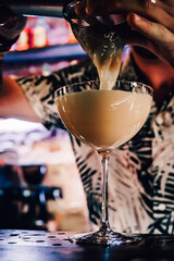 man hand bartender making cocktail in glass on the bar counter
