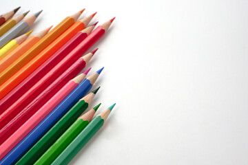 Top view of colored pencils or pastel on white background (Selective focus). Learning, study and presentation concept.