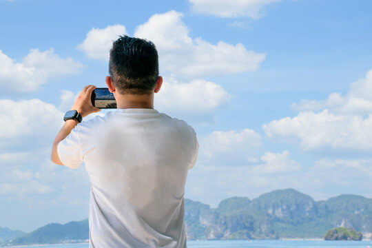Adult man taking a photo in the islands on vacation
