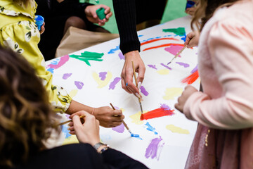 children paint together, child draws paints