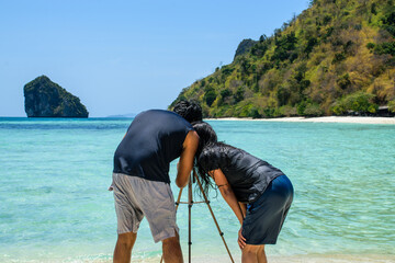 Indian couple taking pictures to the sea