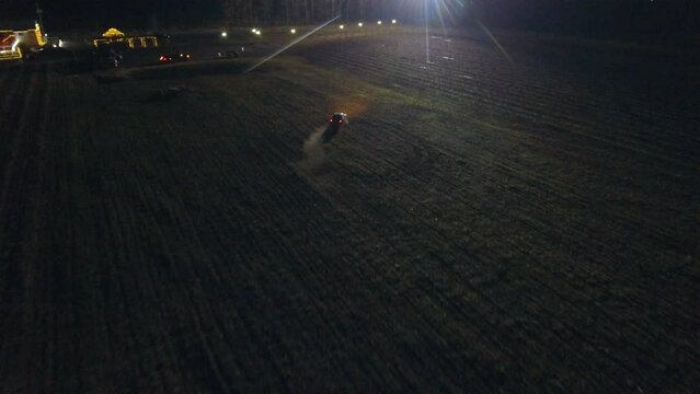 Drone Point Of View On Car Driving On Agricultural Field At Night