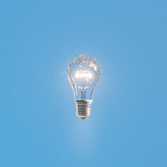 A broken incandescent light bulb shining. Slow-motion shot. Slowly spinning