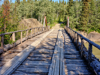 Fototapeta premium One of the old wooden bridges on the Old Alaska Highway built by the Army Corp of Engineers when the Alaska Highway was constructed in the 1940's
