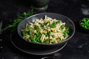 Pasta with green peas and green beans in a bowl
