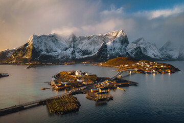 Fascinating fishing village on Lofoten islands in Norway, Scandinavia, Europe. Popular travel destination. Winter-Spring season scenery. Aerial Landscape photography, view on Reine fjord. - 587327522
