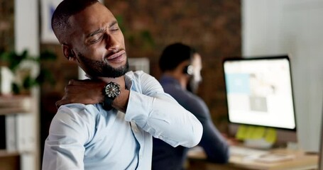 Businessman, shoulder pain and stress at night on computer suffering from burnout or overworked at office. Tired, exhausted and stressed employee man working late holding painful arm or muscle by PC