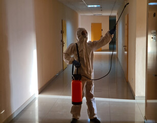 Disinfection in protective suit and respirator treating surfaces with antiseptic in clinic corridor