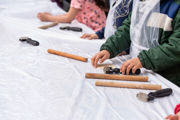 Kids cooking, roll out the dough and making matzah for Jewish holiday Passover Pesach at culinary master class for children outdoor in park. 