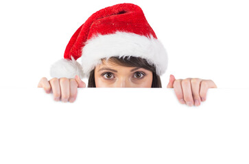 Festive brunette holding a poster