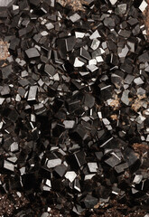 Black andradite garnet mineralogy material crystals. Andradite garnet mineralogy material crystals.  Close up of sample of natural mineral from geological collection Selective focus
