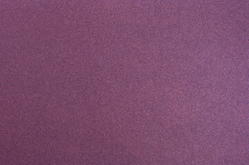 Grainy glitter background texture. Abstract pattern. Fine-grained surface of purple color.