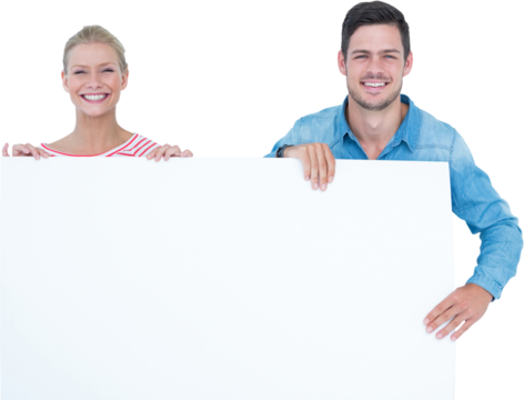 Smiling young couple holding a blank sign