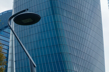 Close-up of a street lamppost and the City Life Generali building in Milan