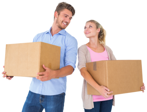 Attractive young couple carrying moving boxes