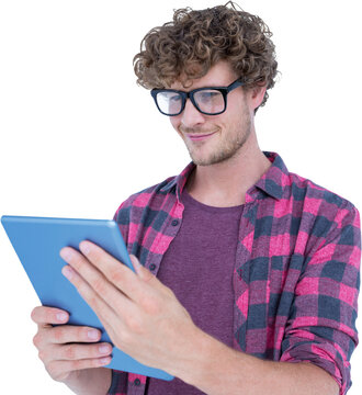 Smiling man wearing geek glasses while using tablet computer