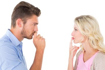 Young couple staying silent with fingers on lips