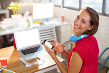 Female business executive text messaging on mobile phone