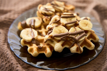 Belgium waffles with chocolate sauce, and banana