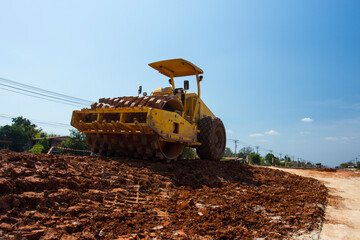The soil compactor is in the work area.Road roller equipped with padfoot drum.