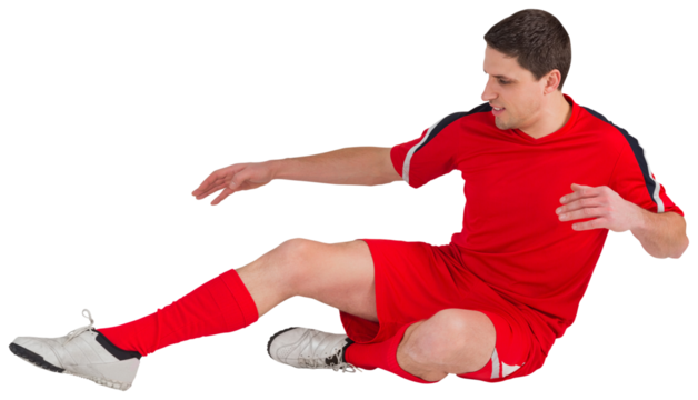 Fit football player jumping and kicking