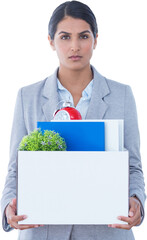 Fired businesswoman holding box of belongings
