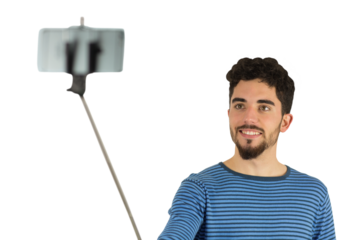 Casual man using a selfie stick