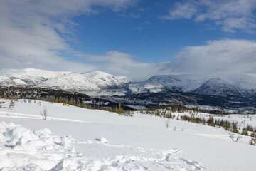 Fototapeta na wymiar Mountain trip to Hilstad mountain on a beautiful winter day with snow and sun, Helgeland, Norway