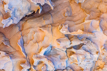 Naklejka premium Close-up of wall of rocky massif in the Cerro de la Calavera, rock formation with irregular texture, grooves and erosions caused by passage of time, sunny day in La Paz, Baja California Sur Mexico