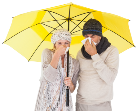 Couple sneezing in tissue while standing under umbrella