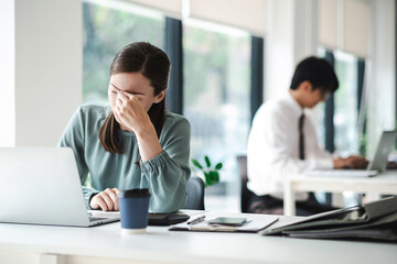 Business woman are stressed while working on laptop, Tired asian businesswoman with headache at office, feeling sick at work