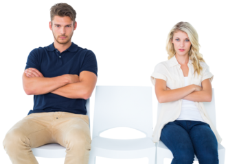 Young couple sitting in chairs not talking during argument