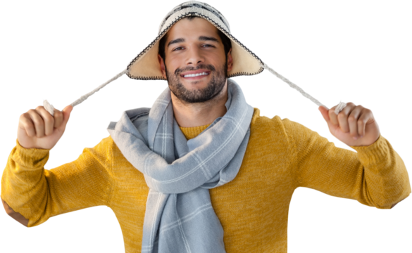 Portrait of smiling man holding wooly hat - Powered by Adobe