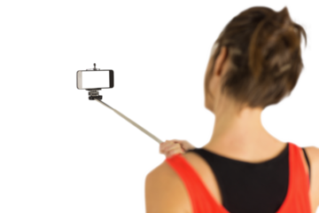 Casual brunette using selfie stick