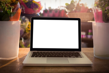 Laptop on table at flower shop