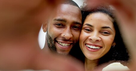Couple, smile and heart hands in home for face, love or romance, affection or care. Emoji, interracial portrait and black man and funny woman laugh with hand gesture for bonding, trust or commitment.