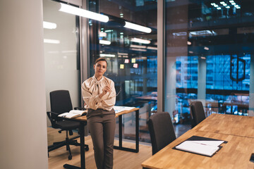 Confident businesswoman working late night in office