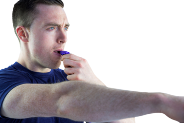 An attentive trainer blowing his whistle