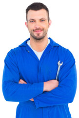 Happy mechanic holding spanner on white background